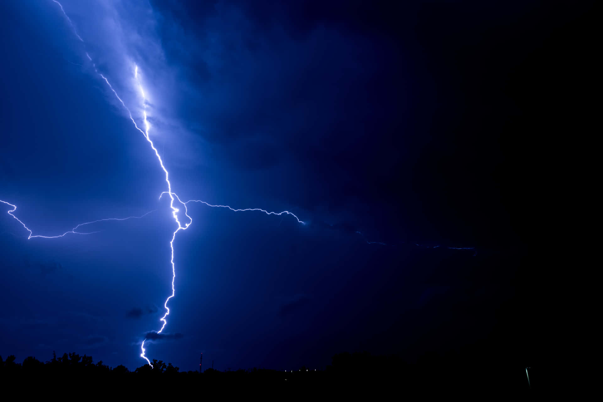 Blue Lightning Strikes Against a Pitch-Black Sky