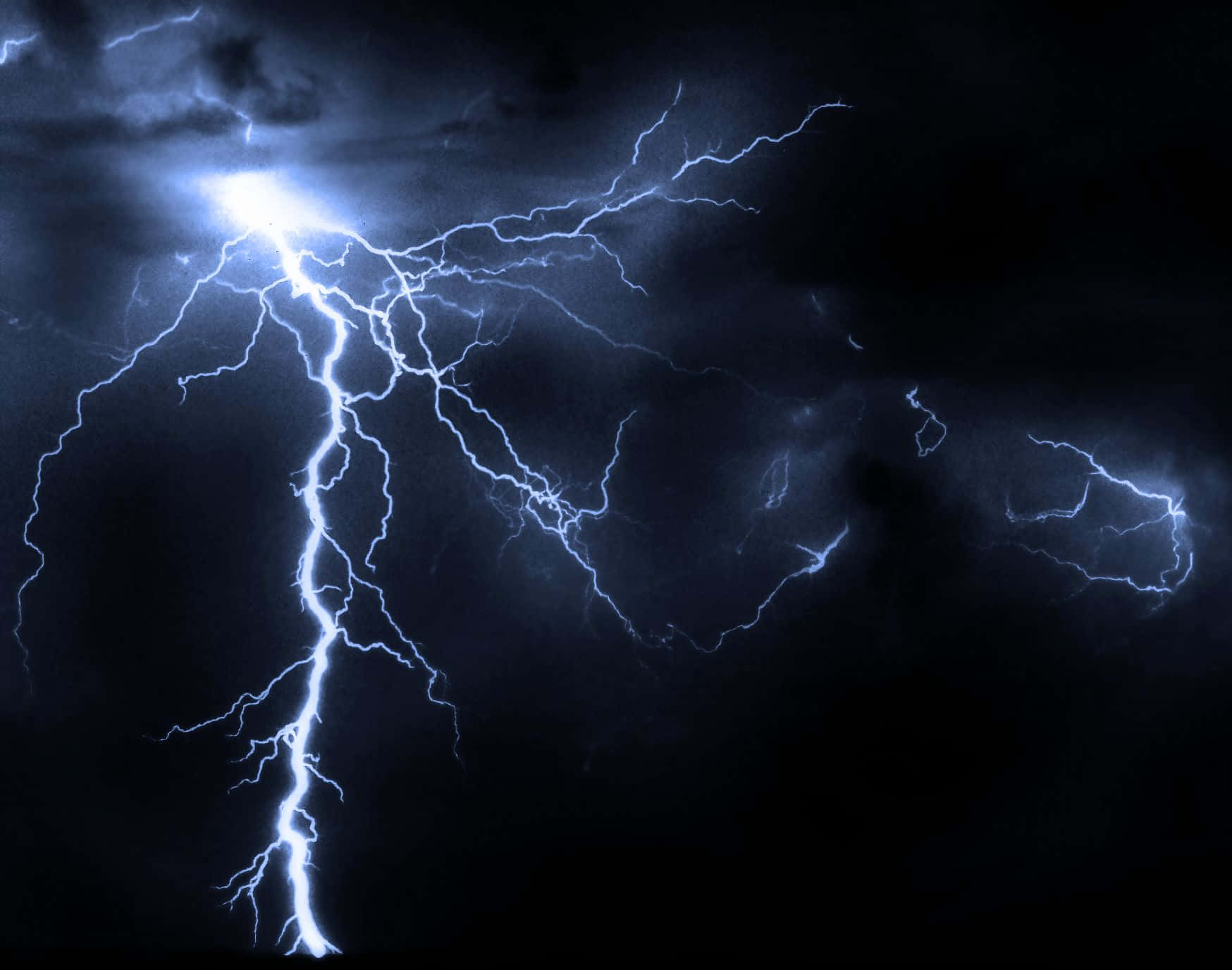 Electric Blues - A mesmerizing image of blue lightning in a dark night sky Wallpaper