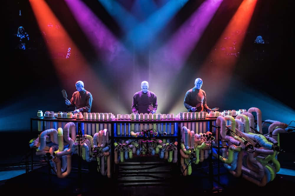 Get Lost In The Rhythm Of The Blue Man Group Wallpaper