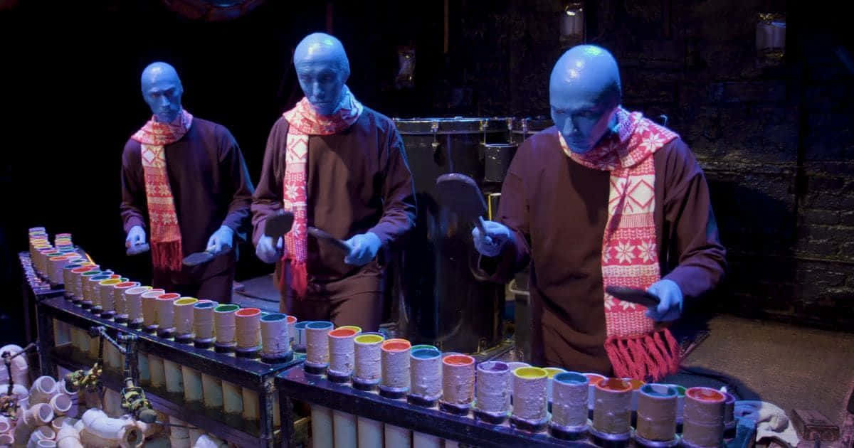 Enjoy the show with the Blue Man Group Wallpaper