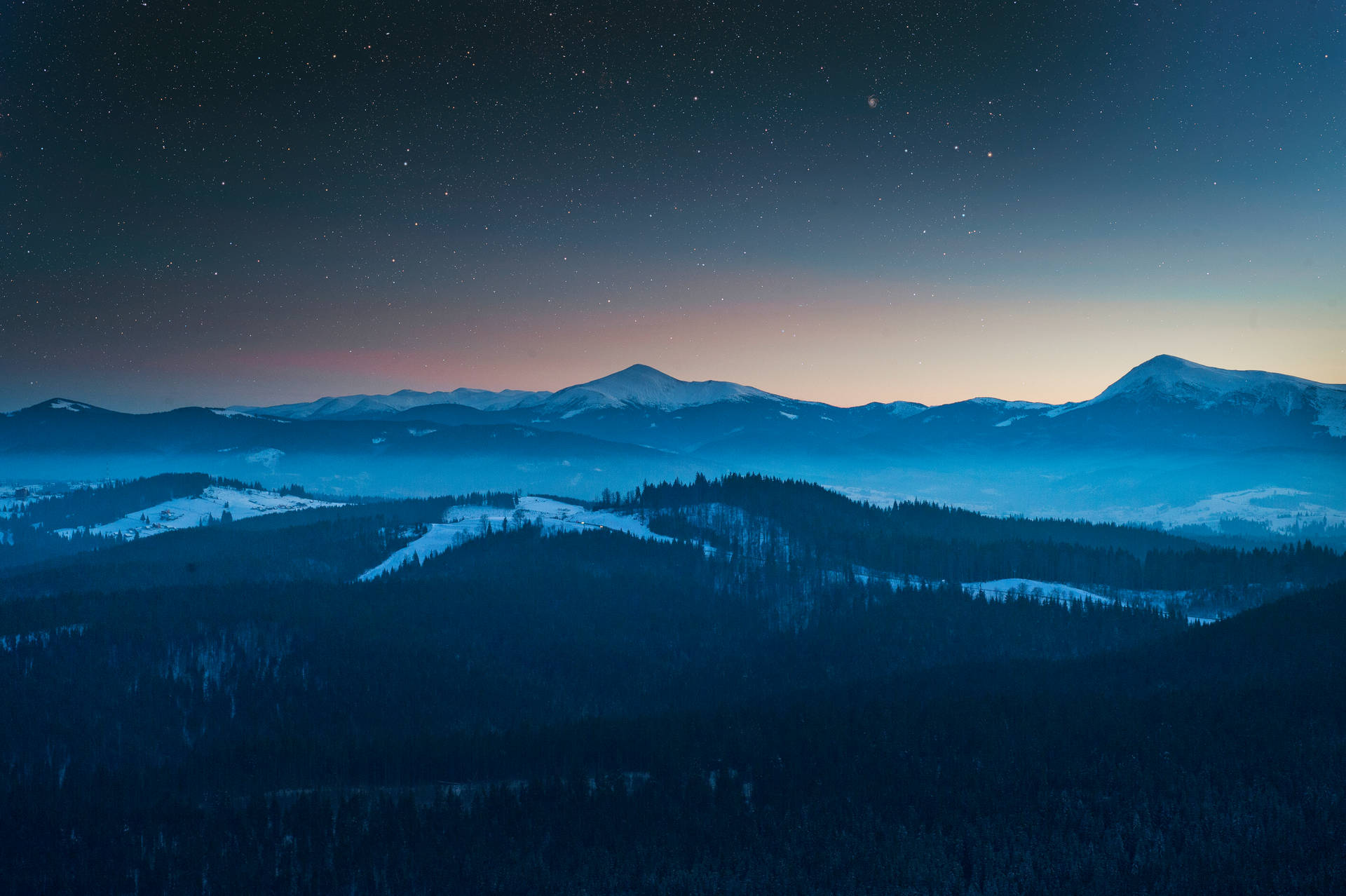 Blue mountain landscape beneath a night sky Wallpaper