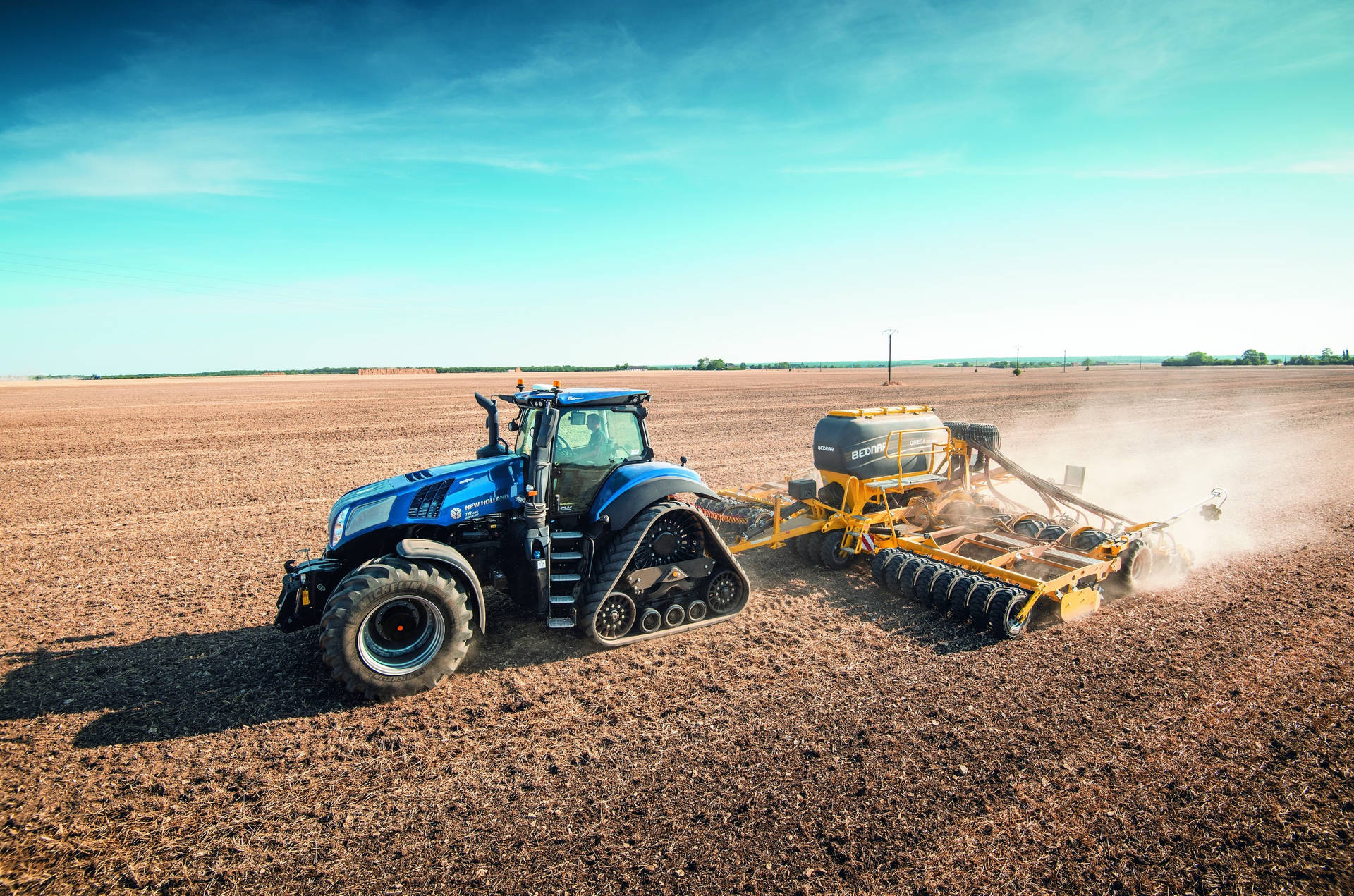 Caption: Majestic Blue New Holland Tractor in the Countryside Wallpaper