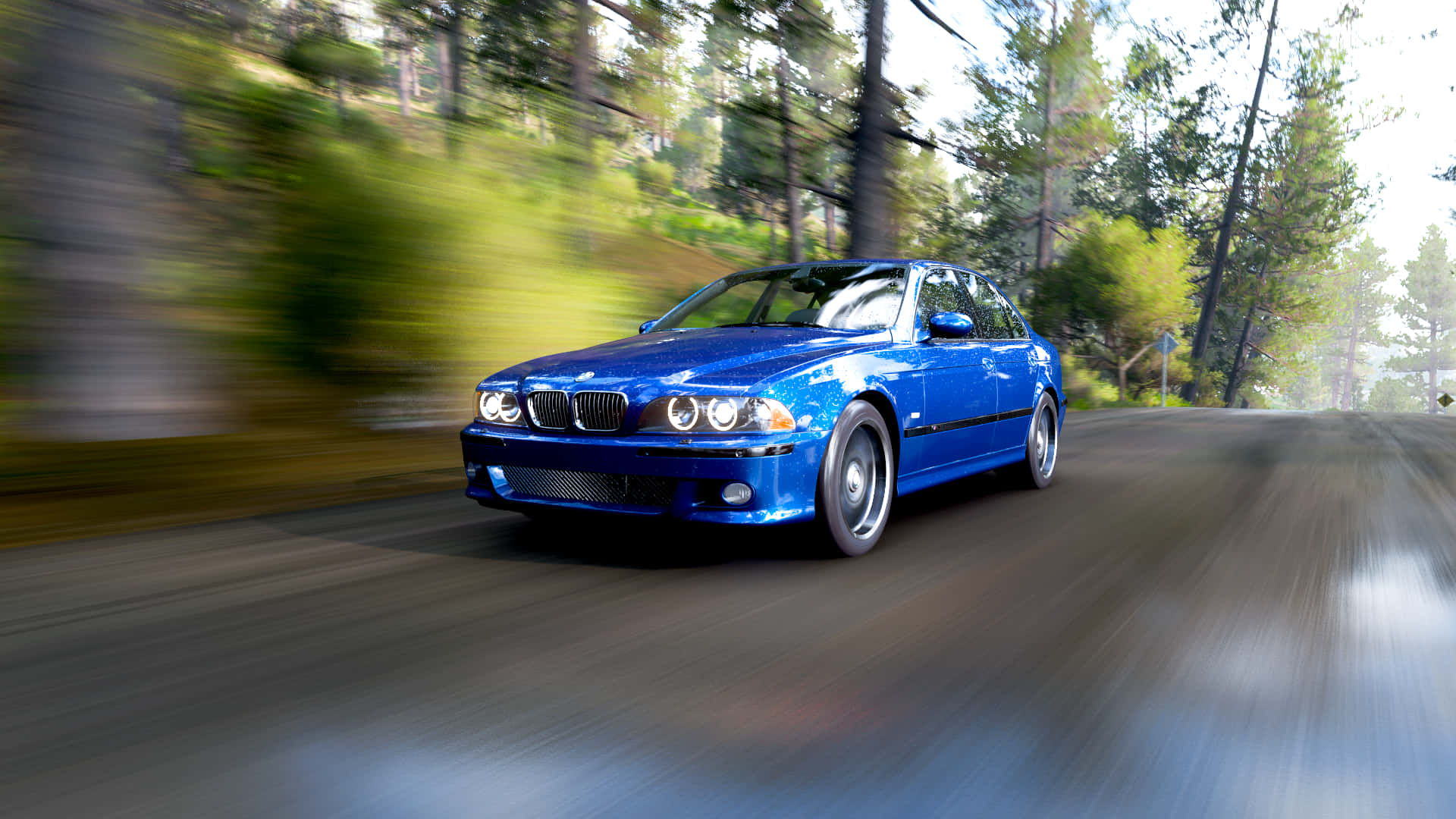 Blue_ Sedan_ Speeding_ Through_ Forest_ Road.jpg Wallpaper