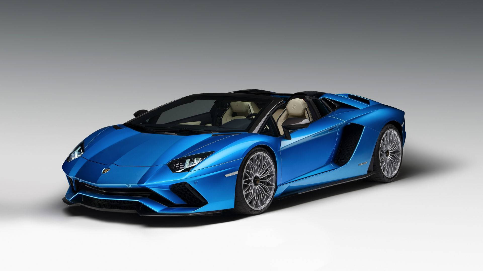 Blå sportsvogn Lamborghini uden tag på en byvej Wallpaper