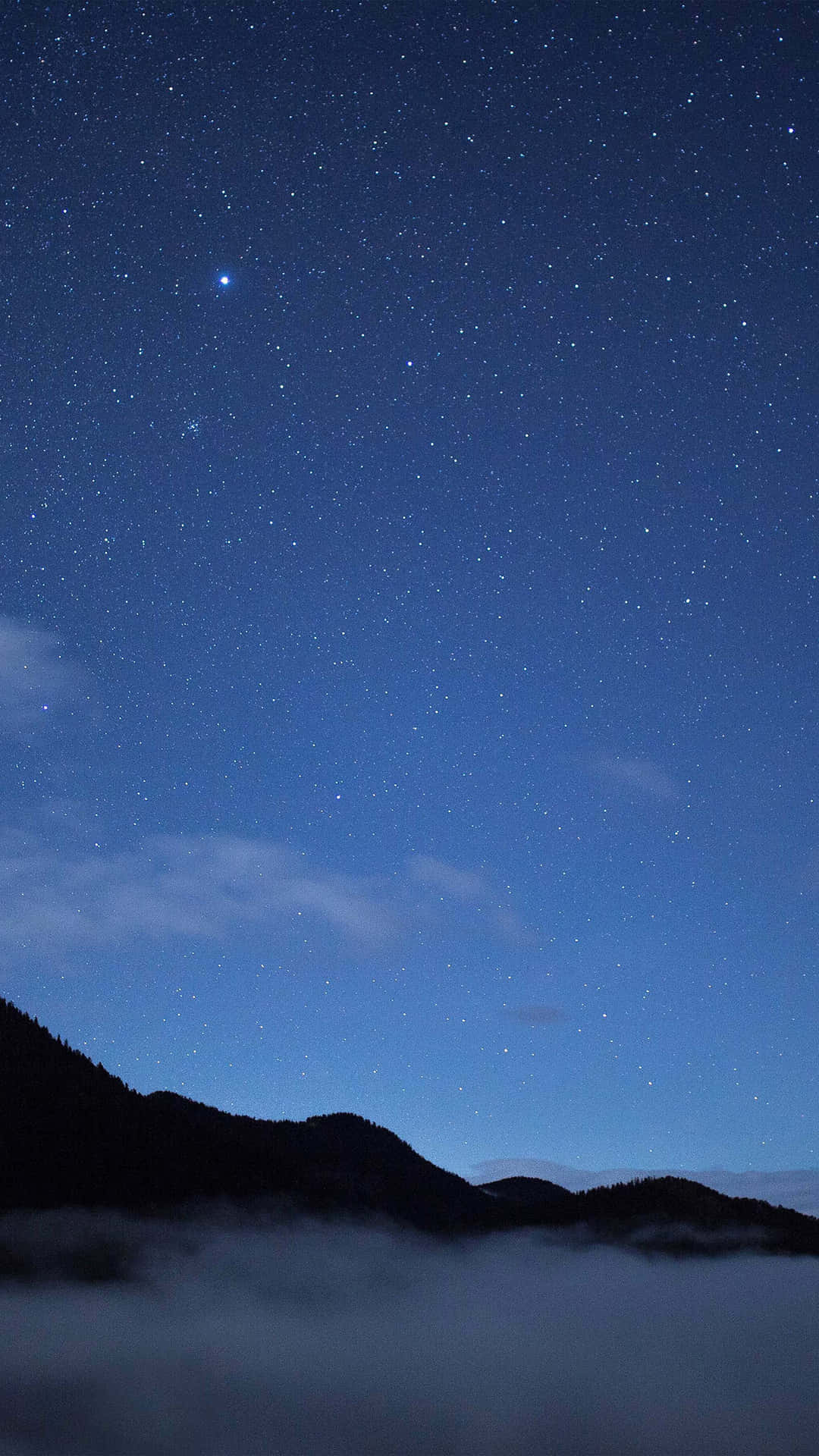 A beautiful blue star sparkles brightly against a deep night sky.