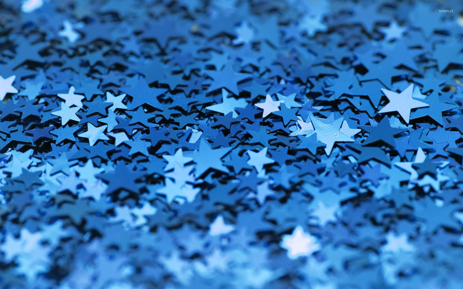 A view of a night sky filled with bright blue stars Wallpaper