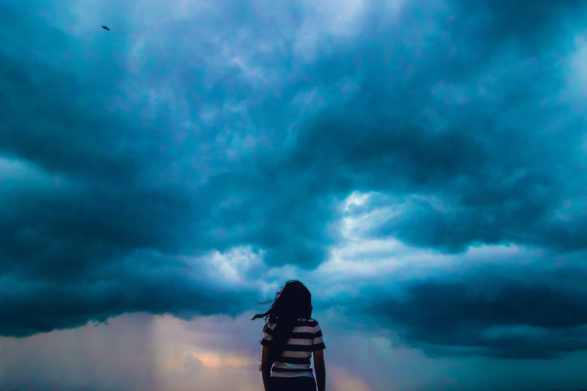 Blue Storm Clouds Over Girl Wallpaper