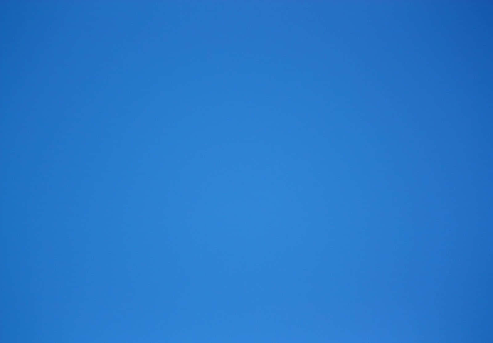 A Blue Sky With A Kite Flying In It