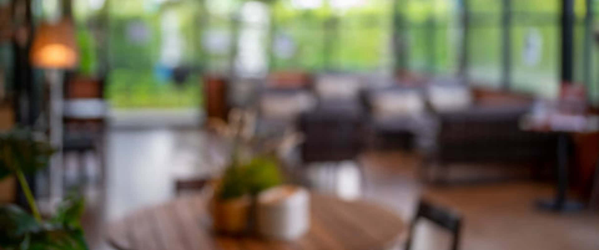 A Blurry Image Of A Restaurant With Tables And Chairs