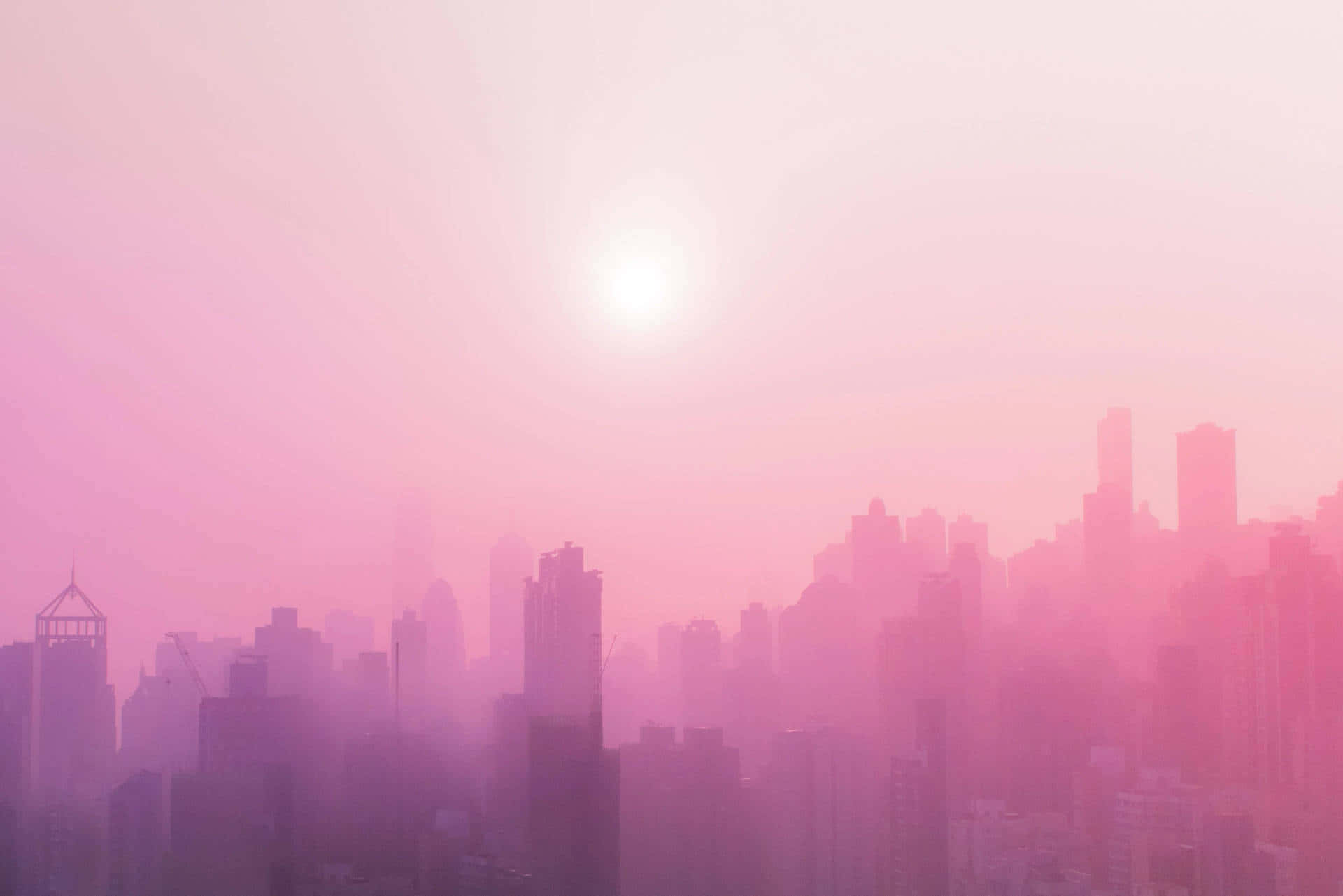 A Pink Sky With A City In The Background