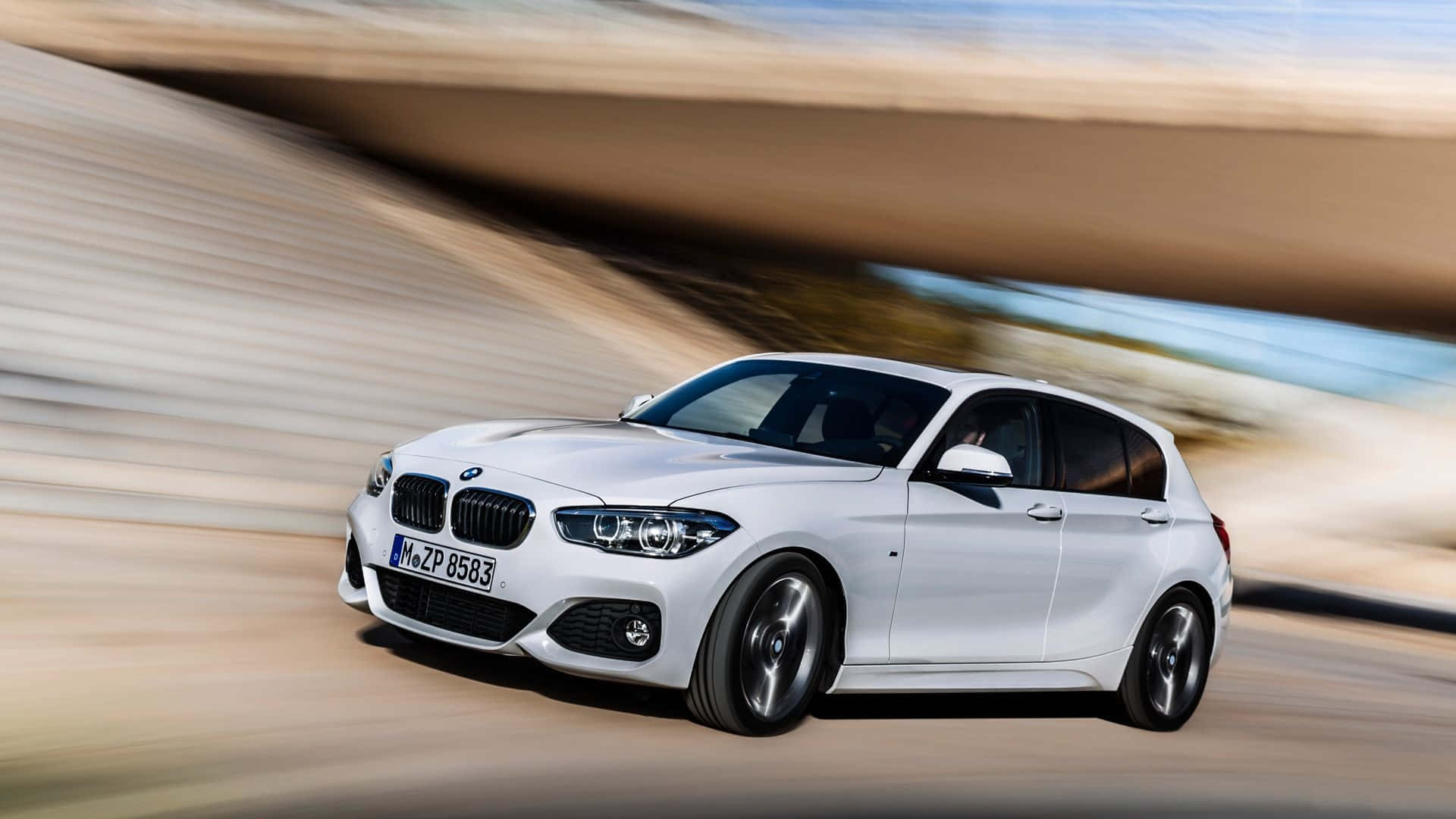 Sleek BMW 1 Series Showcased on an Open Road Wallpaper