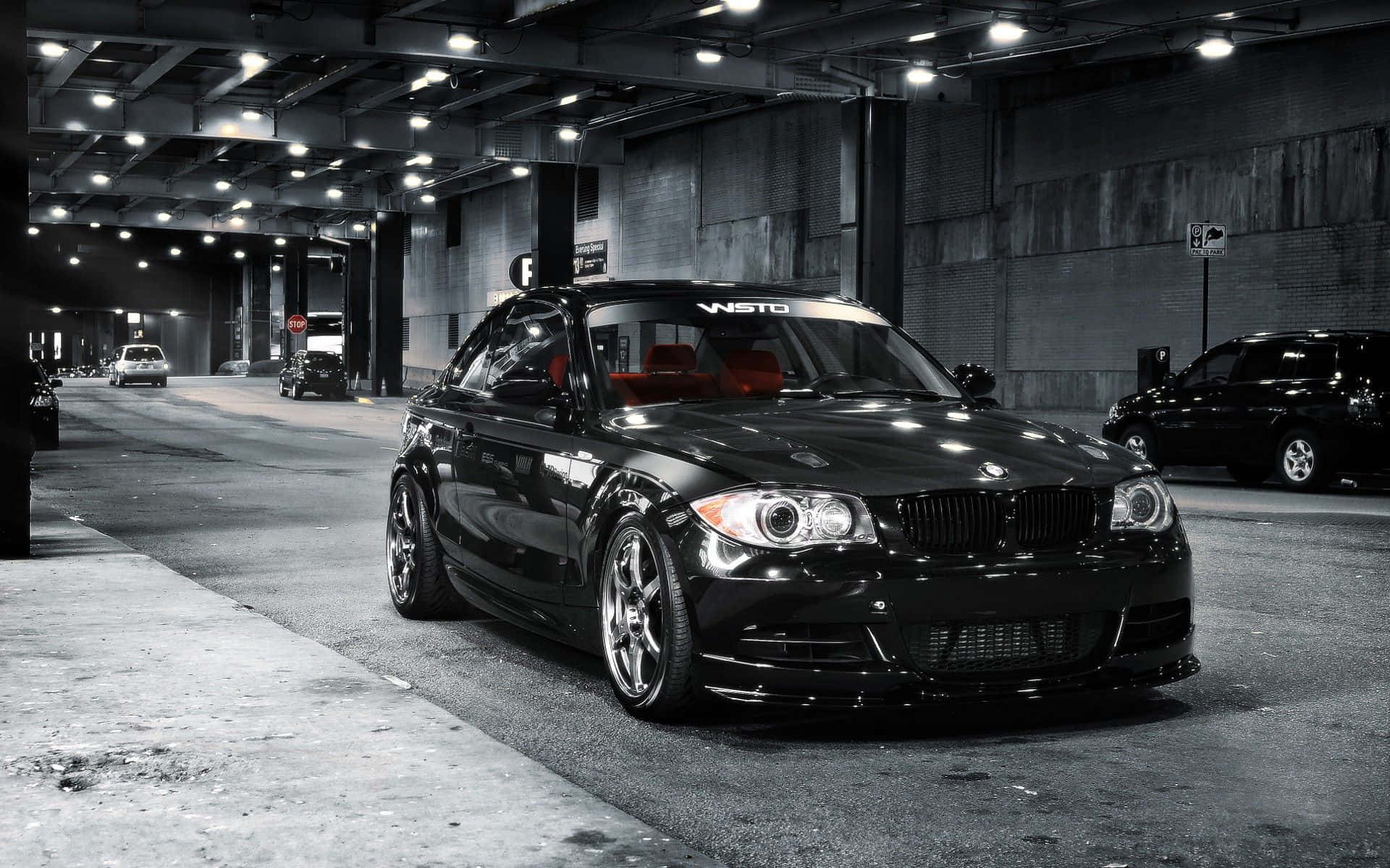 Sleek and stylish BMW 1 Series parked on a city street Wallpaper