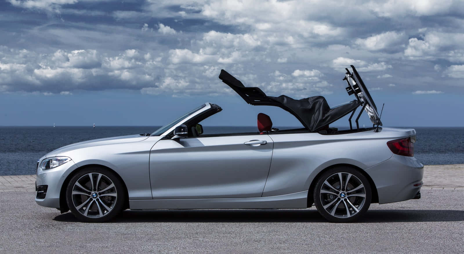 Sleek and Powerful BMW 2 Series Coupe on a Scenic Drive Wallpaper