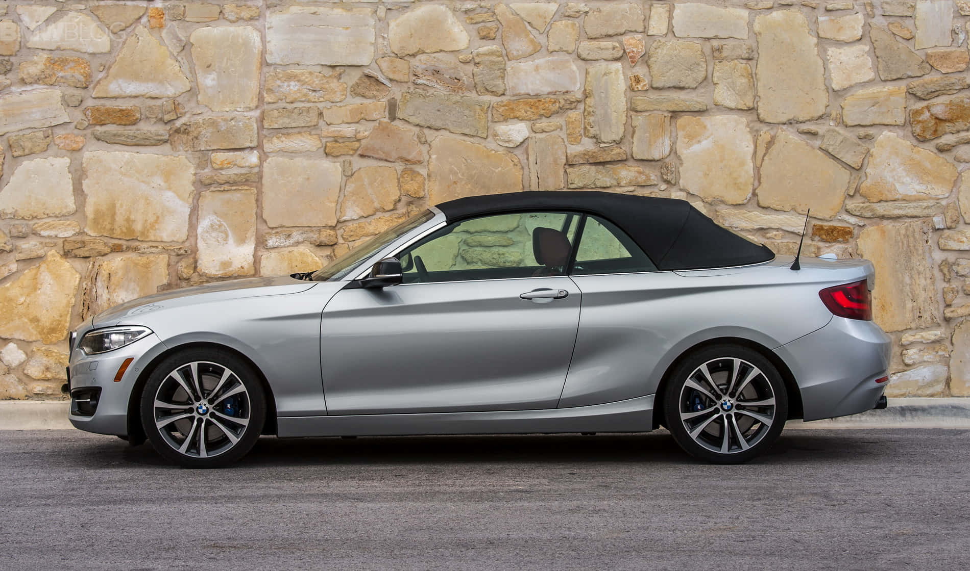 Sleek BMW 2 Series in motion on a scenic open road Wallpaper