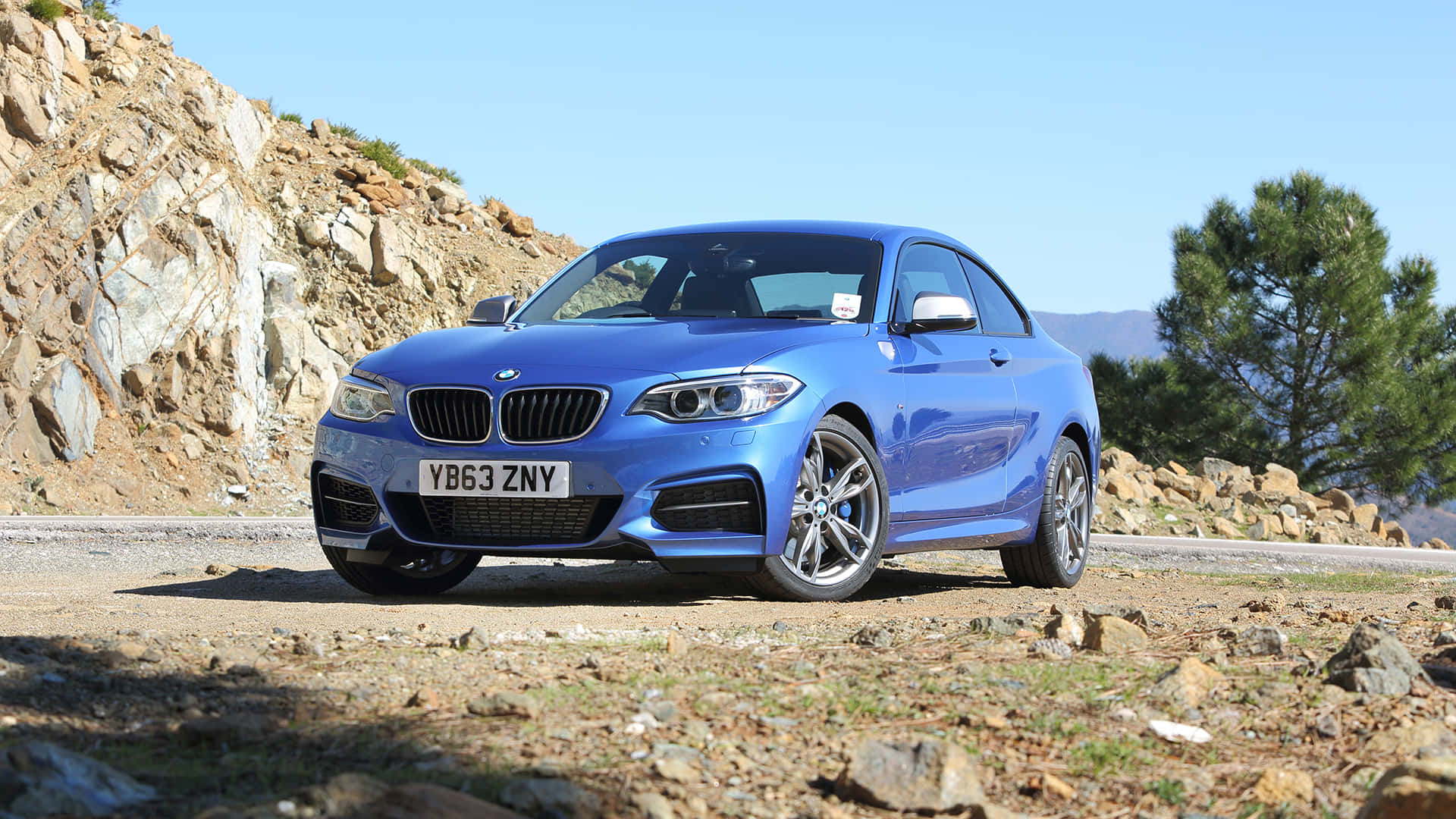 Stunning BMW 2 Series in motion on a scenic road Wallpaper