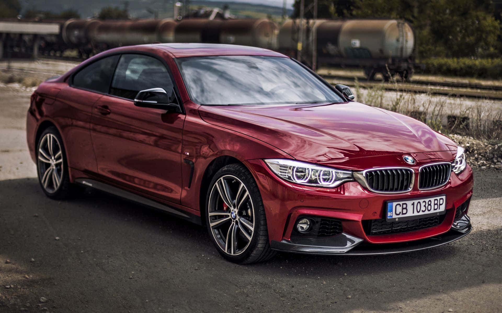 Sleek BMW 4 Series in motion on a scenic road Wallpaper