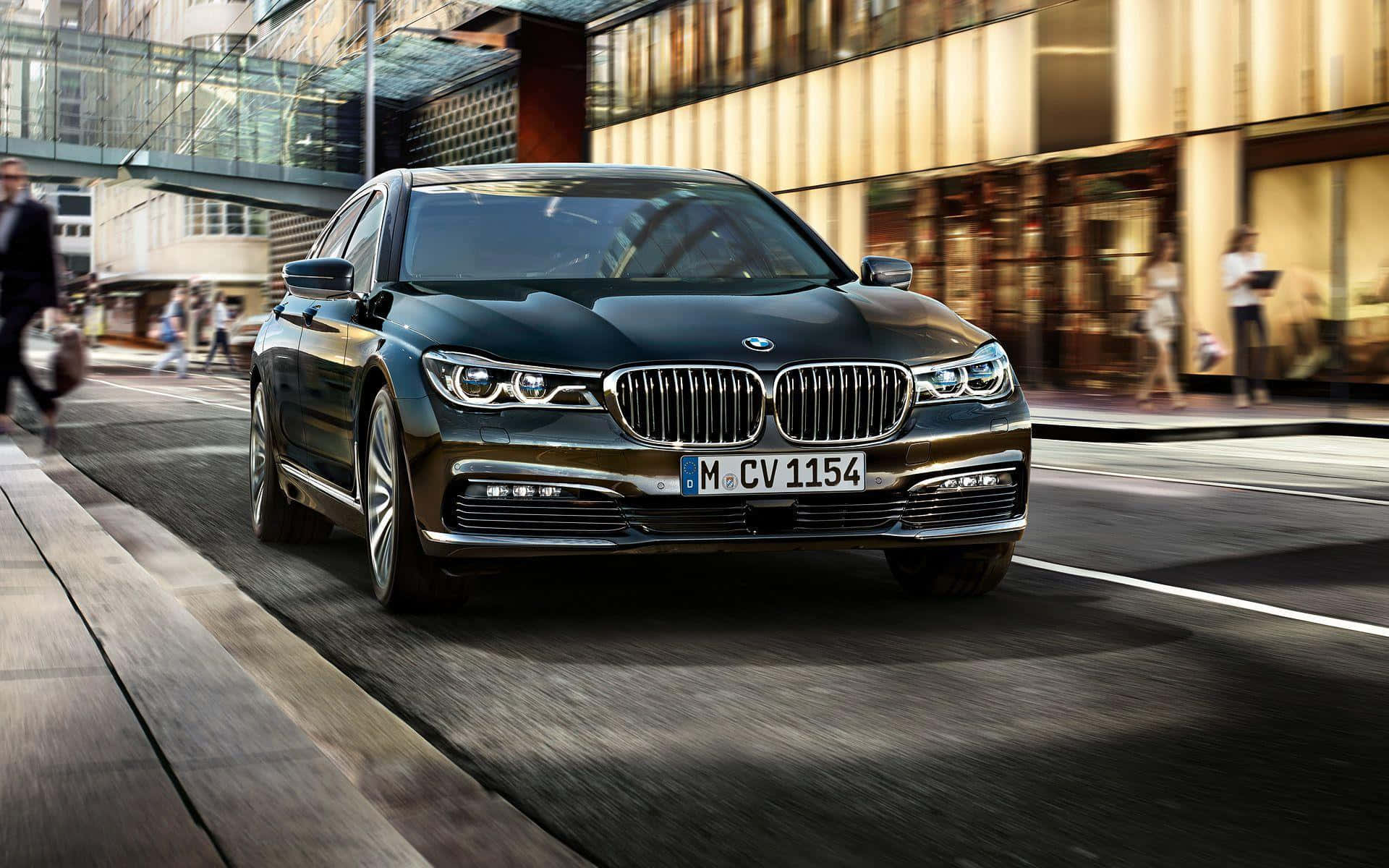 Sleek BMW 7 Series in Motion on a Scenic Road Wallpaper