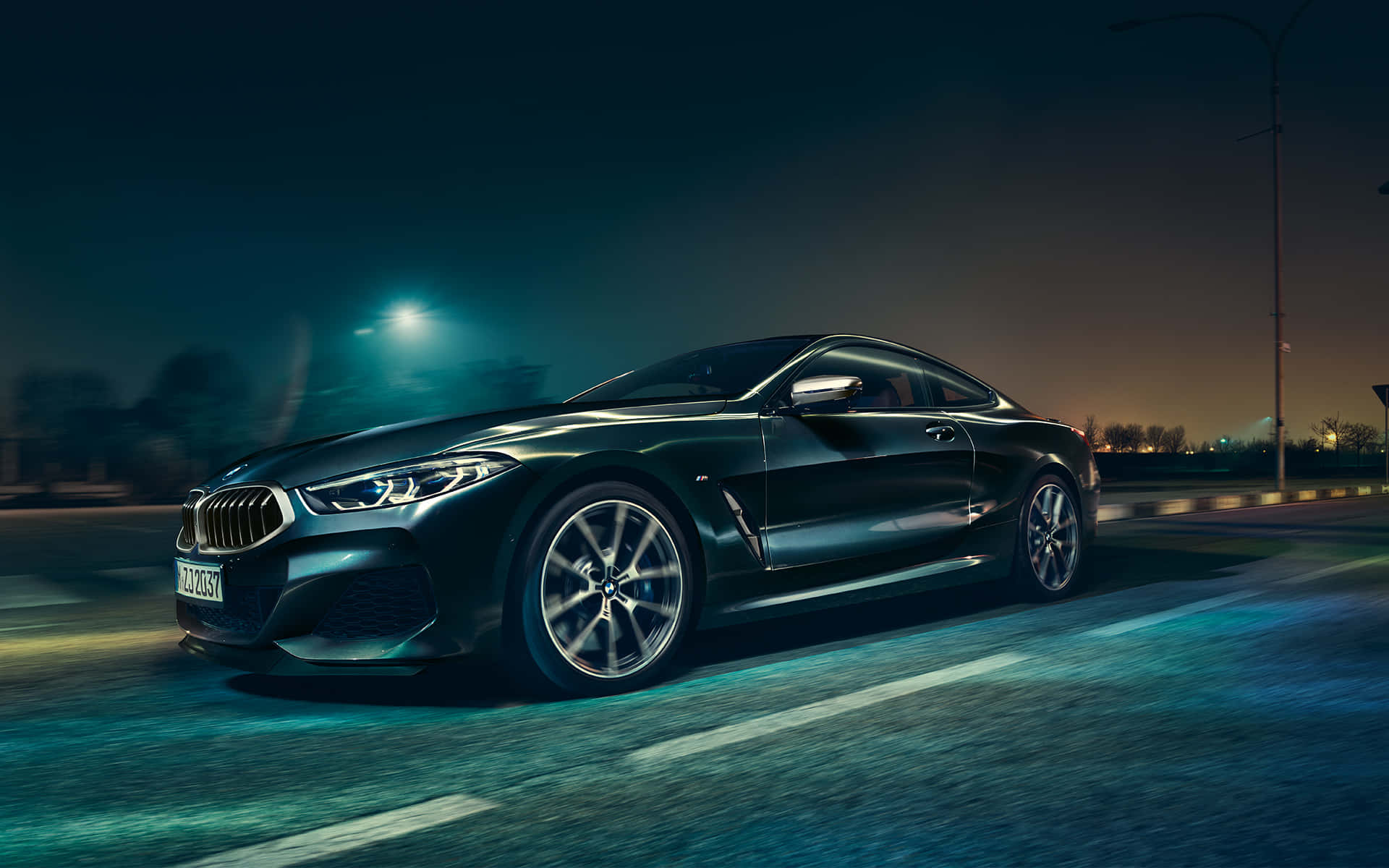 Sleek BMW 8 Series Coupe in a Dynamic Night Setting Wallpaper