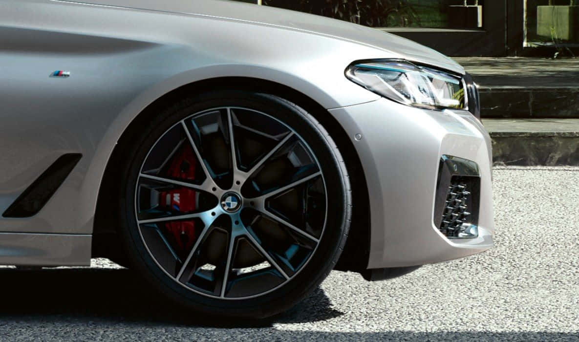 The Front Wheel Of A Silver Bmw M5 Wallpaper