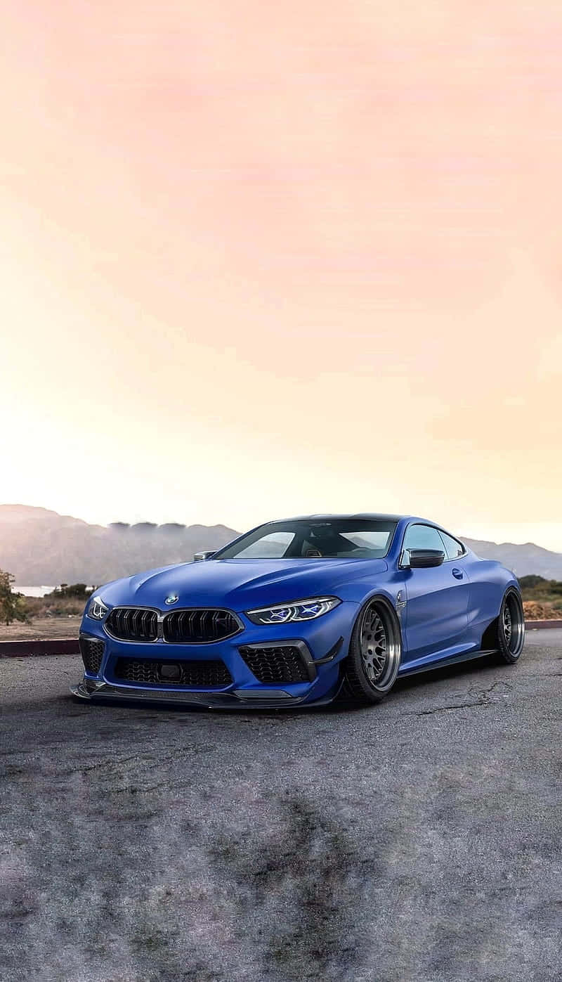 Download Blue Bmw M8 4K Mobile By The Sunrise Wallpaper | Wallpapers.Com