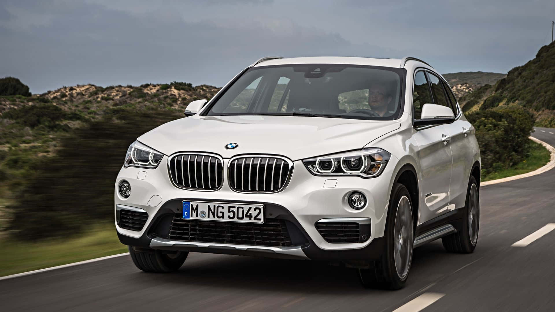 Dynamic BMW X1 on the road Wallpaper