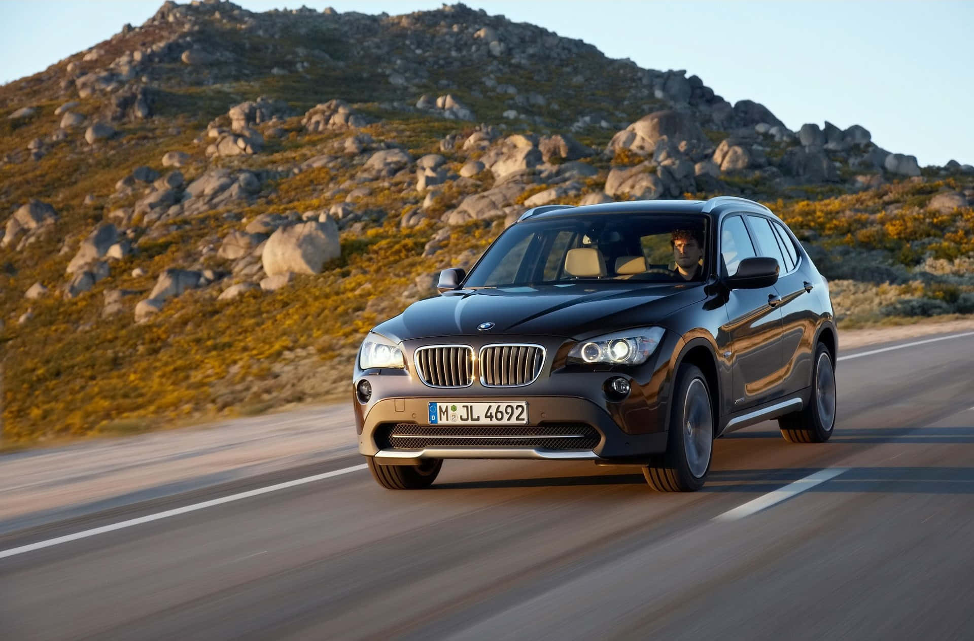 Stunning BMW X1 in Motion on a Scenic Road Wallpaper