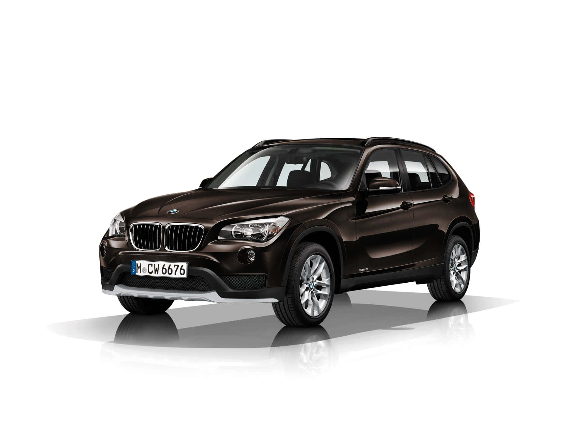 Stylish BMW X1 in motion on a stunning scenic route Wallpaper