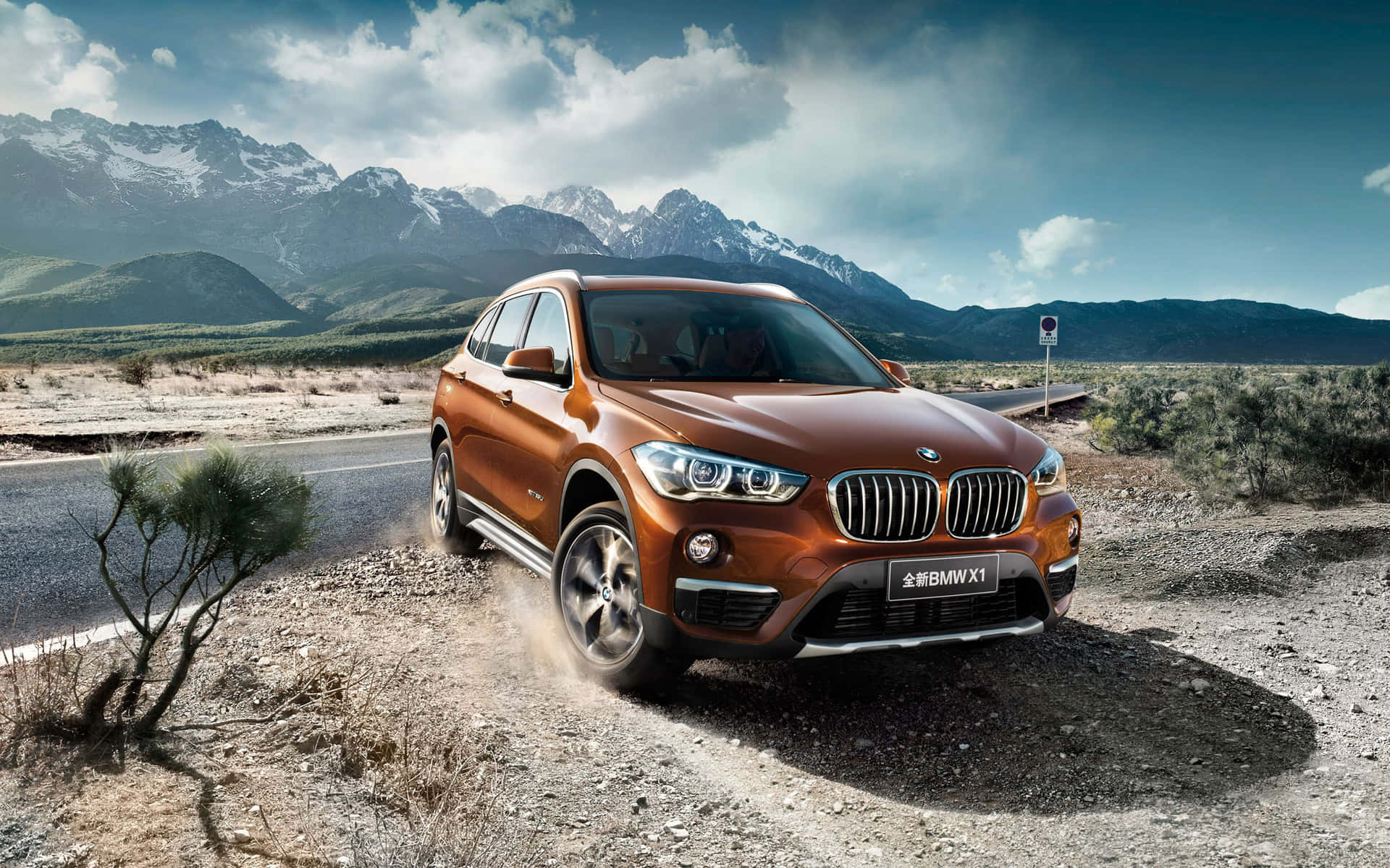 Sleek and Stylish BMW X1 Cruising on the Road Wallpaper