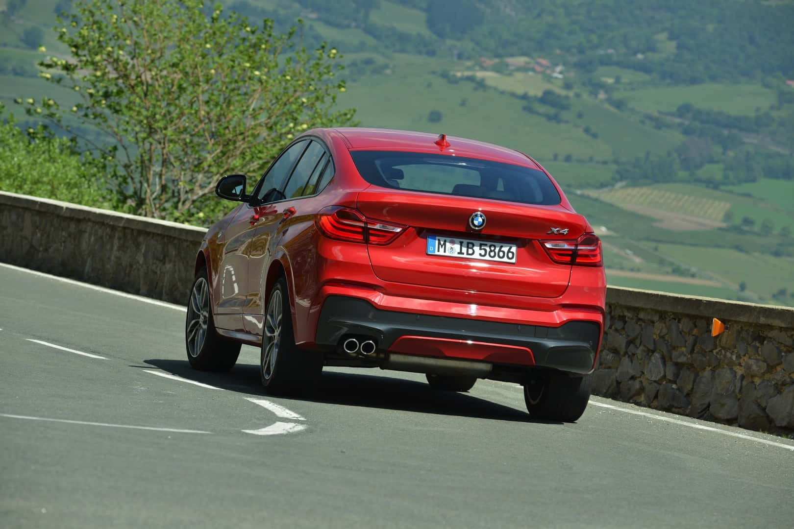 Powerful and Refined - The BMW X4 in its Elegant Stance Wallpaper