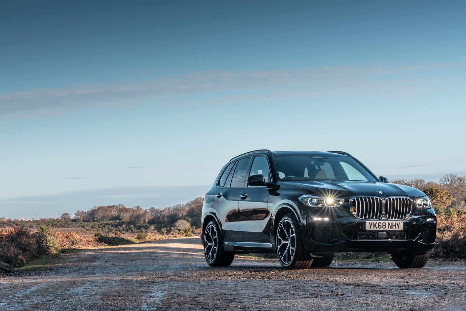 Beautiful BMW X5 cruising down a scenic road Wallpaper