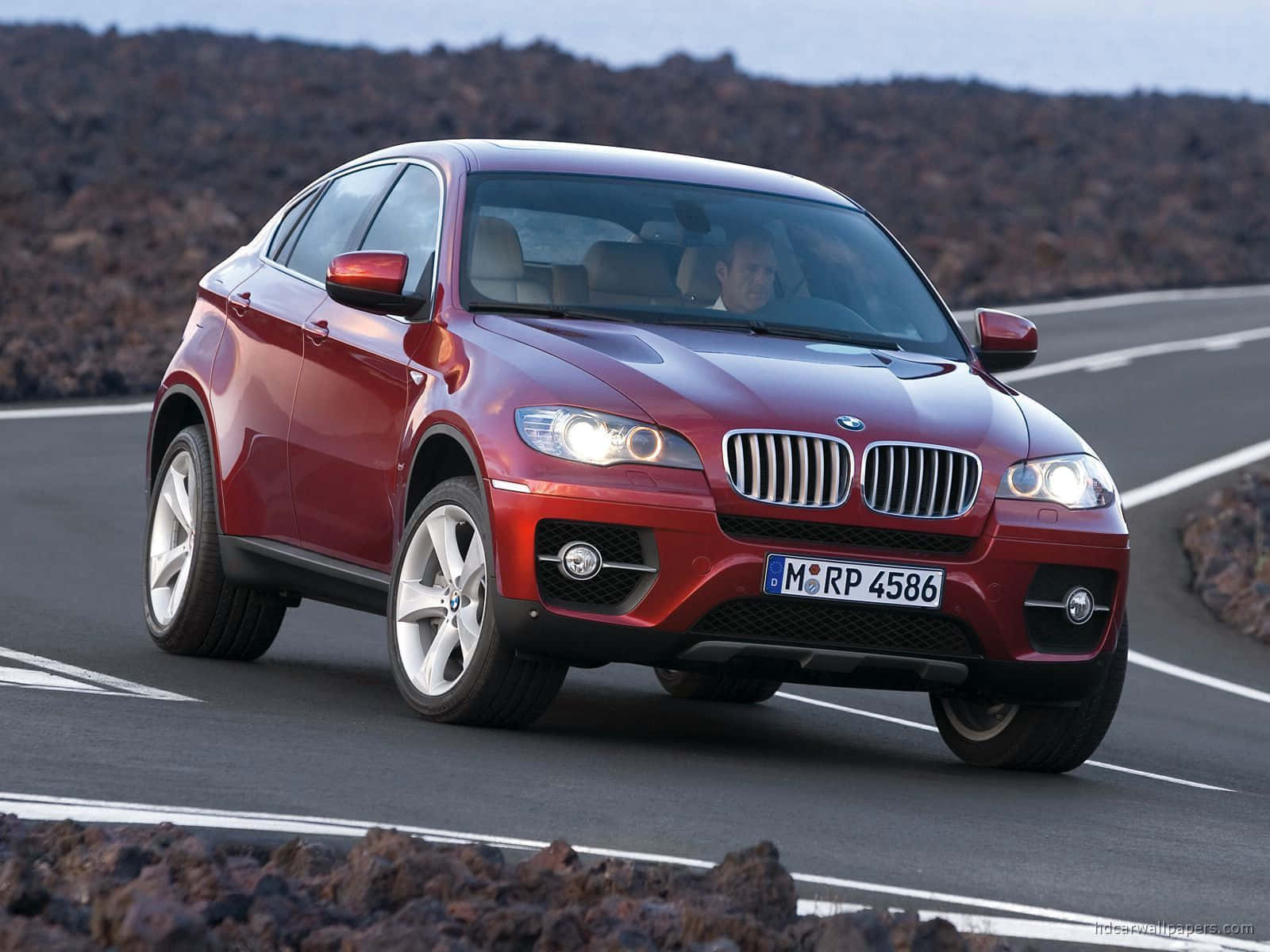 Sleek and Powerful BMW X6 in a Dramatic Setting Wallpaper