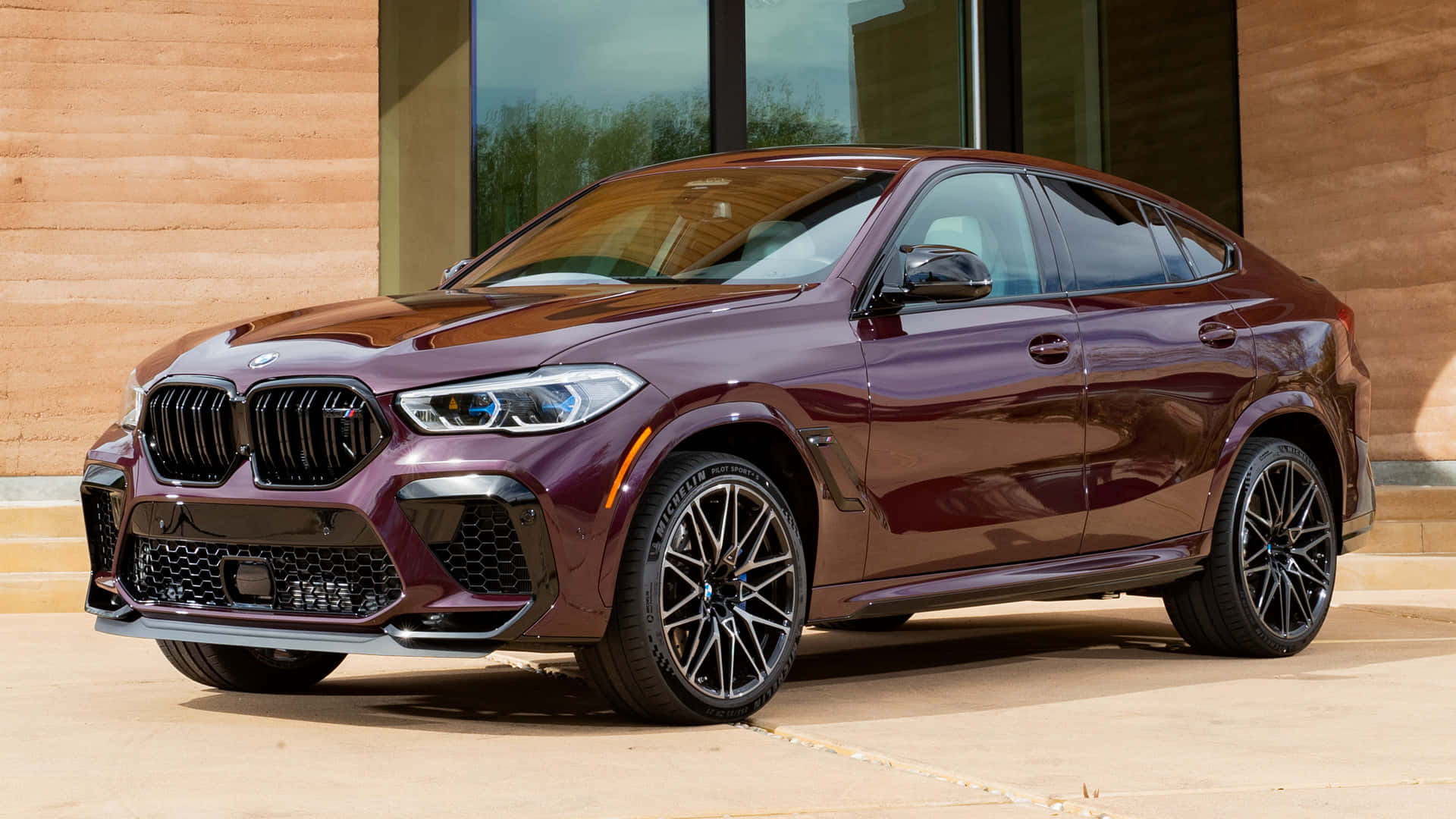 The 2019 Bmw X4 Is Parked In Front Of A Building