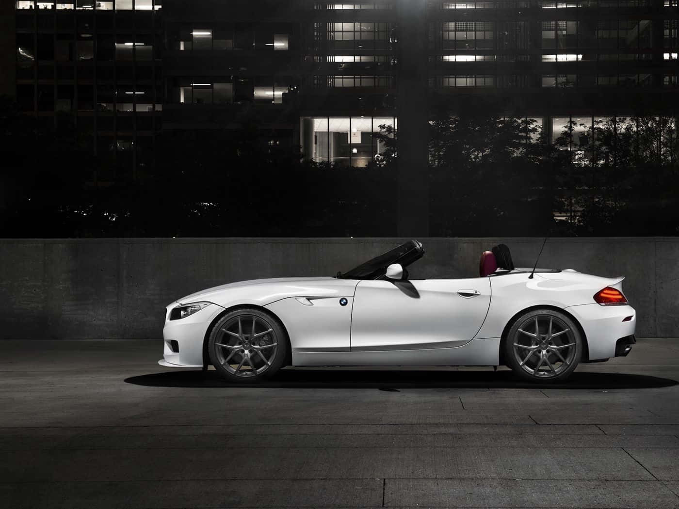 BMW Z4 Roadster Cruising Down a Scenic Road Wallpaper