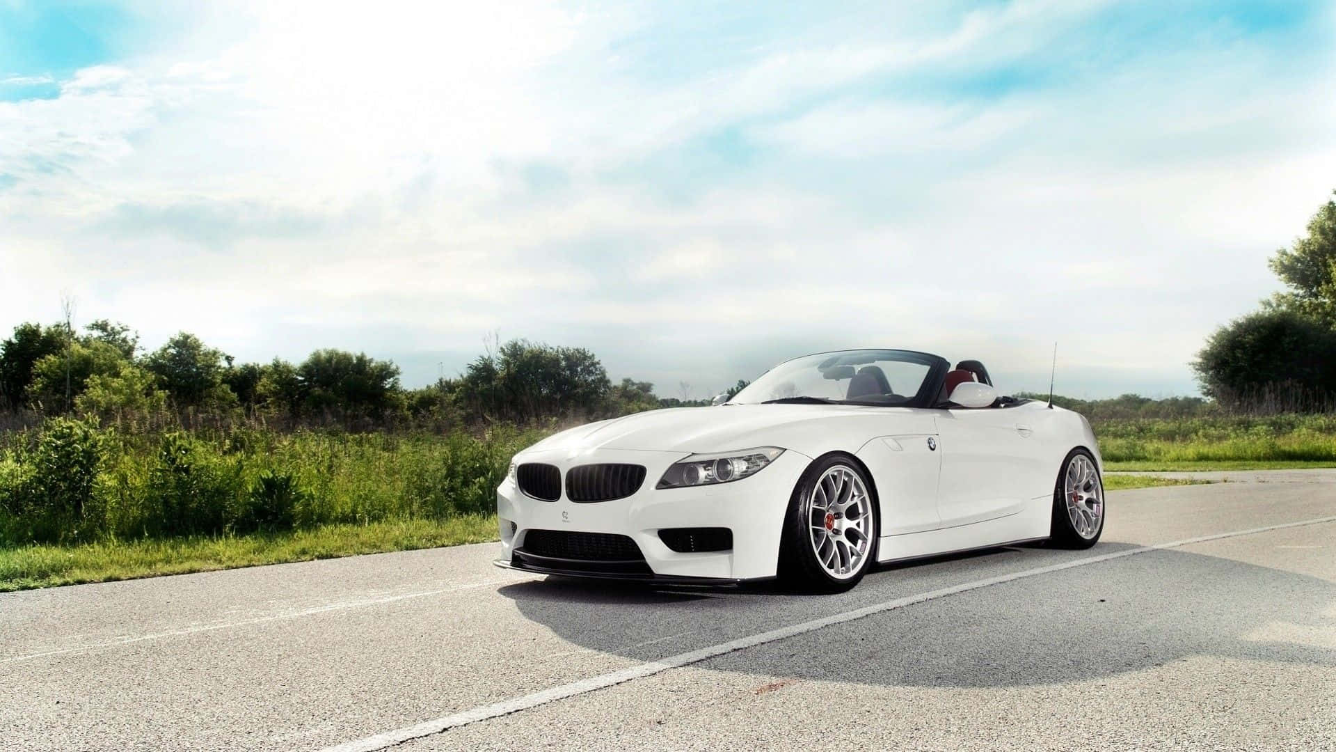 Sleek BMW Z4 Roadster cruising on the open road Wallpaper