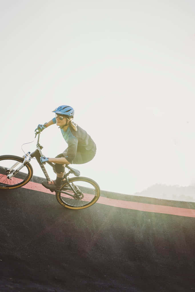 "A daring bmx rider performing a daredevil stunt high above the street!" Wallpaper