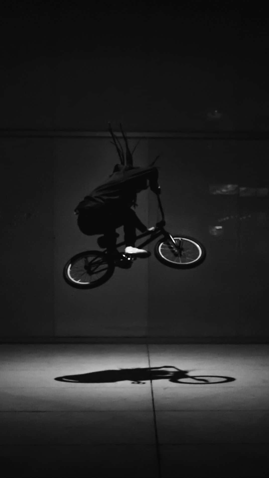 "Performing a backflip with smooth style and confidence on the BMX ramp!" Wallpaper