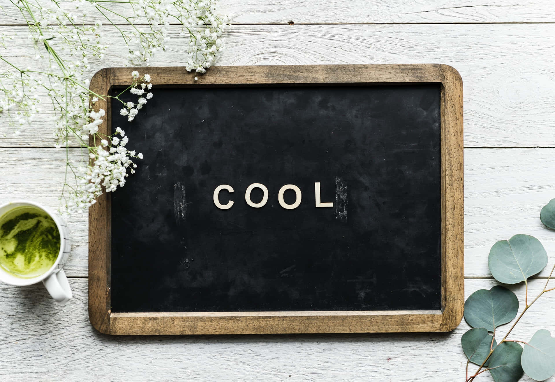 A Blackboard With The Word Cool On It And A Cup Of Tea