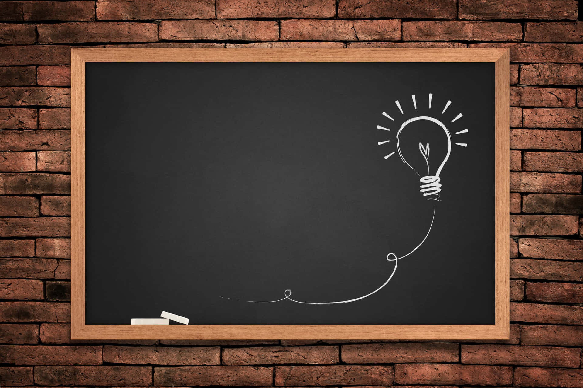 A Blackboard With A Light Bulb Hanging From It