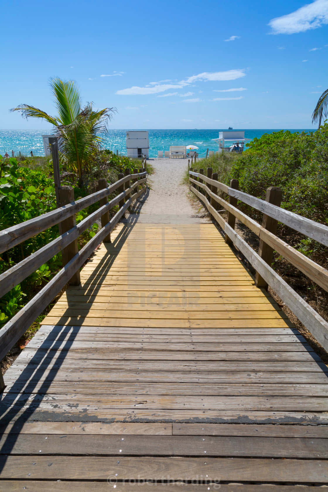 A Wooden Walkway Leading To The Beach