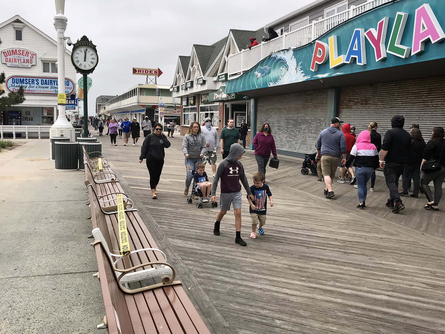 A Boardwalk With People Walking Down It
