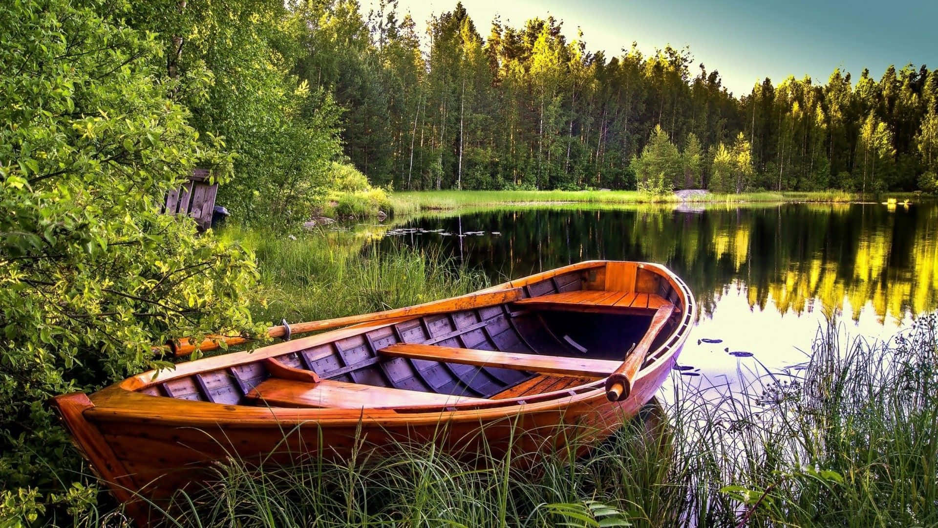 Serene Lake Boating Adventure Wallpaper