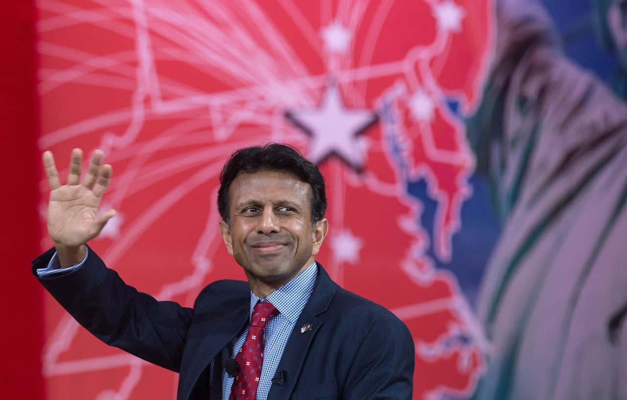 Bobby Jindal Waving to Audience on Stage Wallpaper