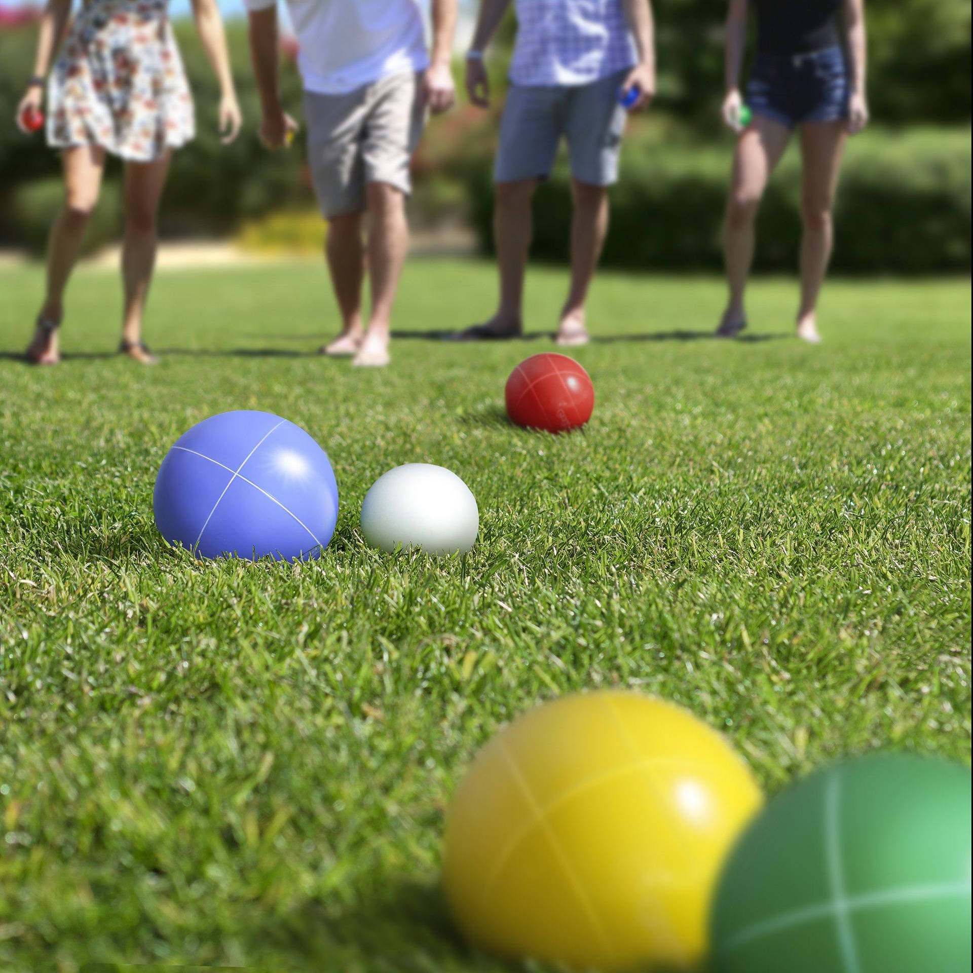 Bocce Ball On Grass With Players' Feet Wallpaper