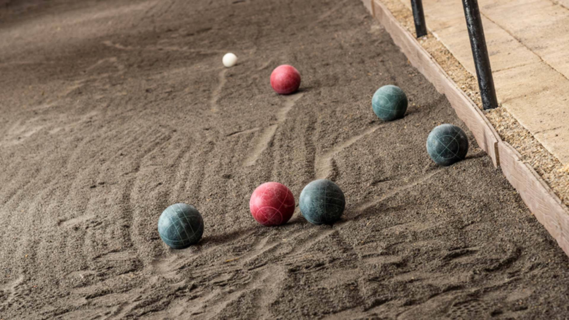 Ready for the Toss - Bocce Ball on Sand Court Wallpaper