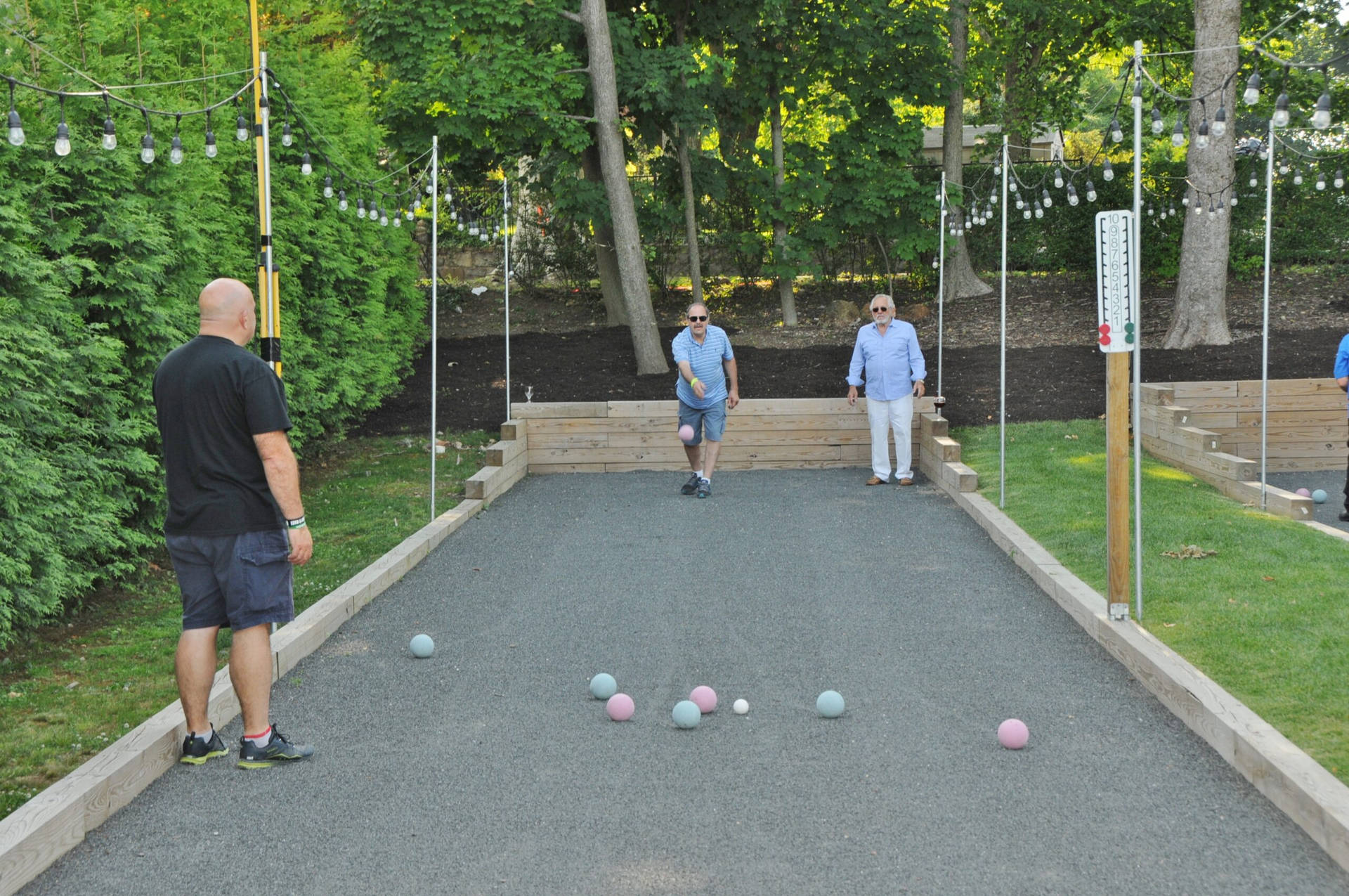 Bocce Ball People Playing On Court Wallpaper