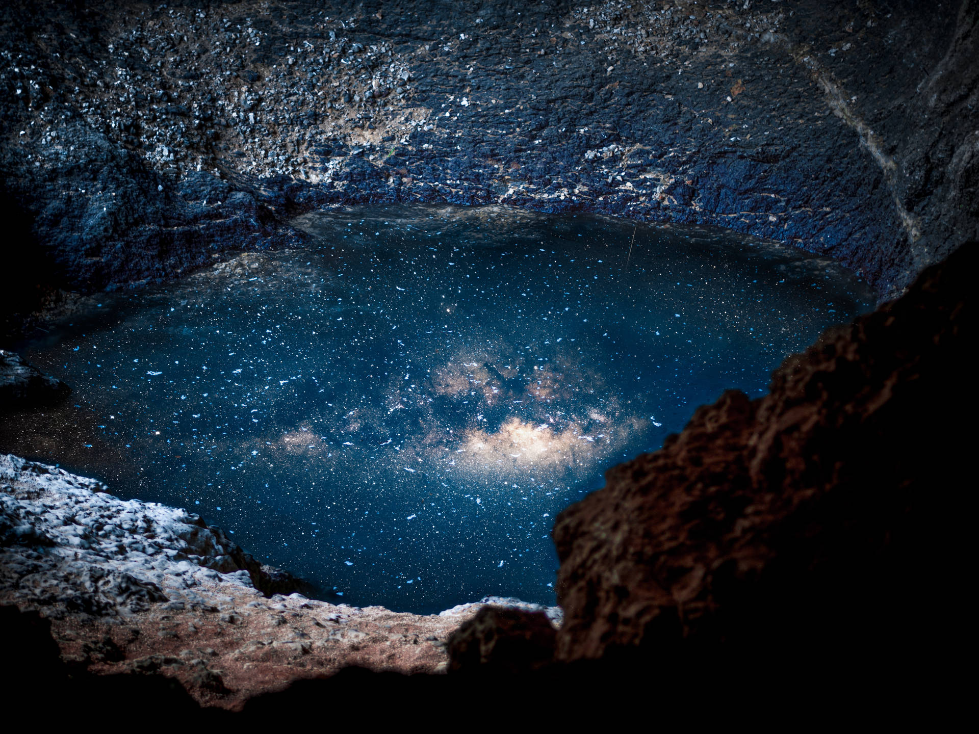 An extraordinary HD wallpaper of body of water reflecting galaxy