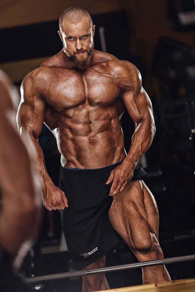 Bodybuilder Displaying Muscles Wallpaper