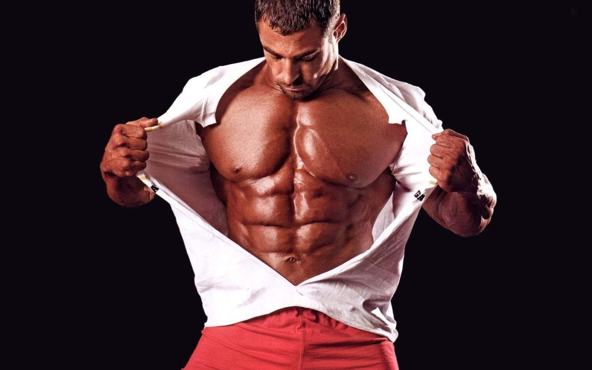 Picture Of Male Bodybuilder Ripping Off His Shirt Picture