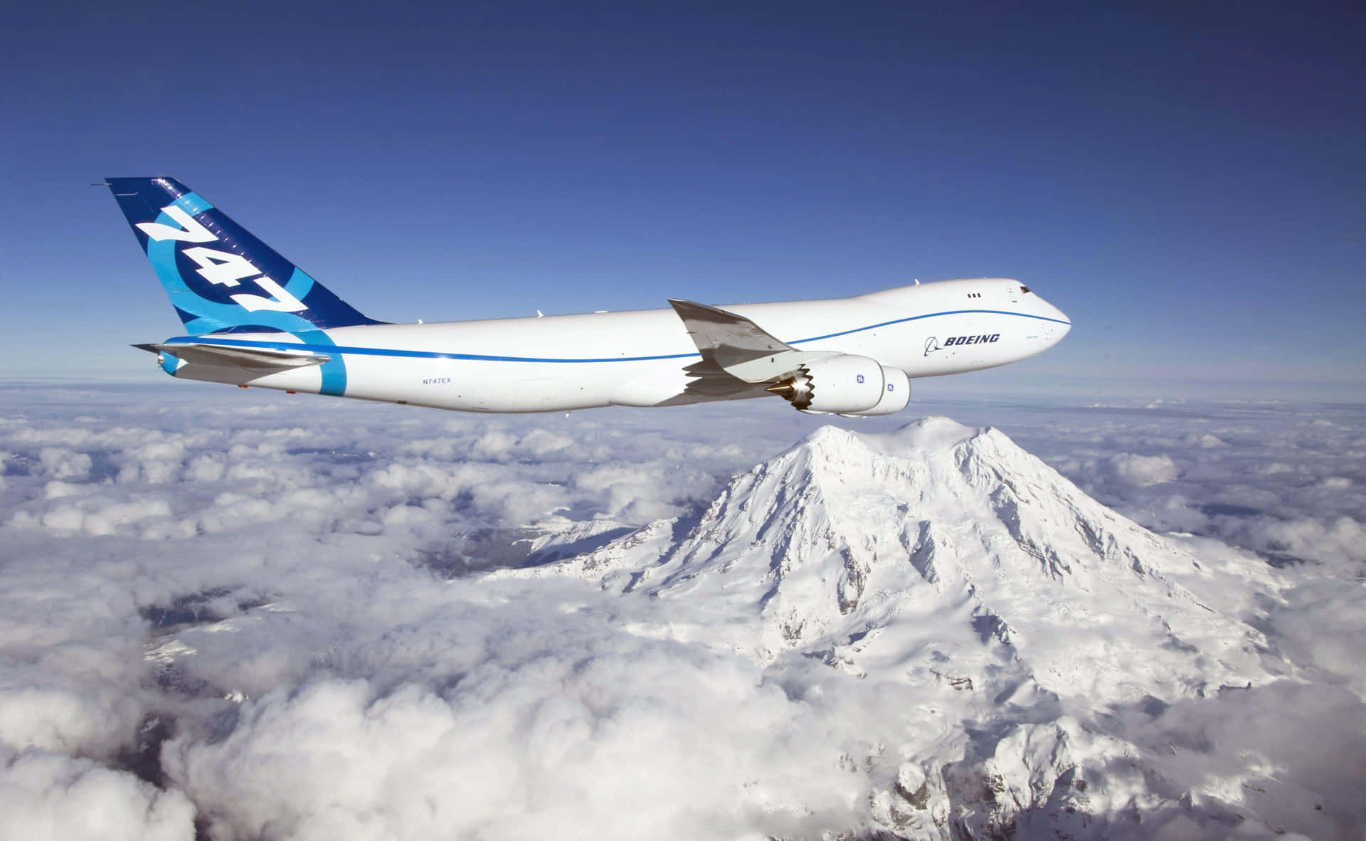 Boeing Aircraft Over Mountain Peaks Wallpaper