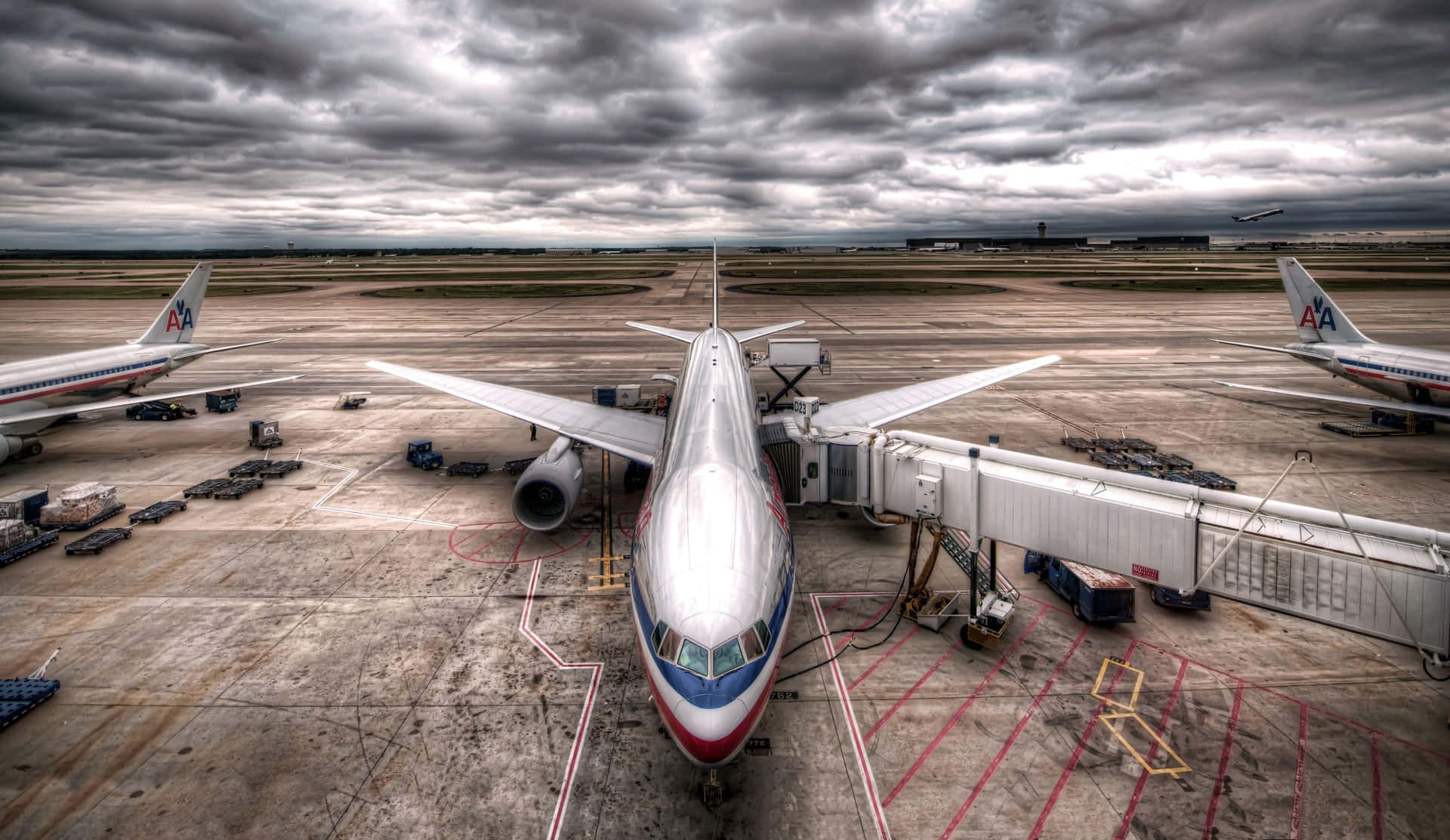Boeing Aircraftat Gate Under Cloudy Skies Wallpaper